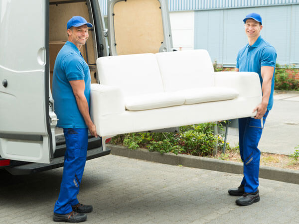 Men moving a white couch